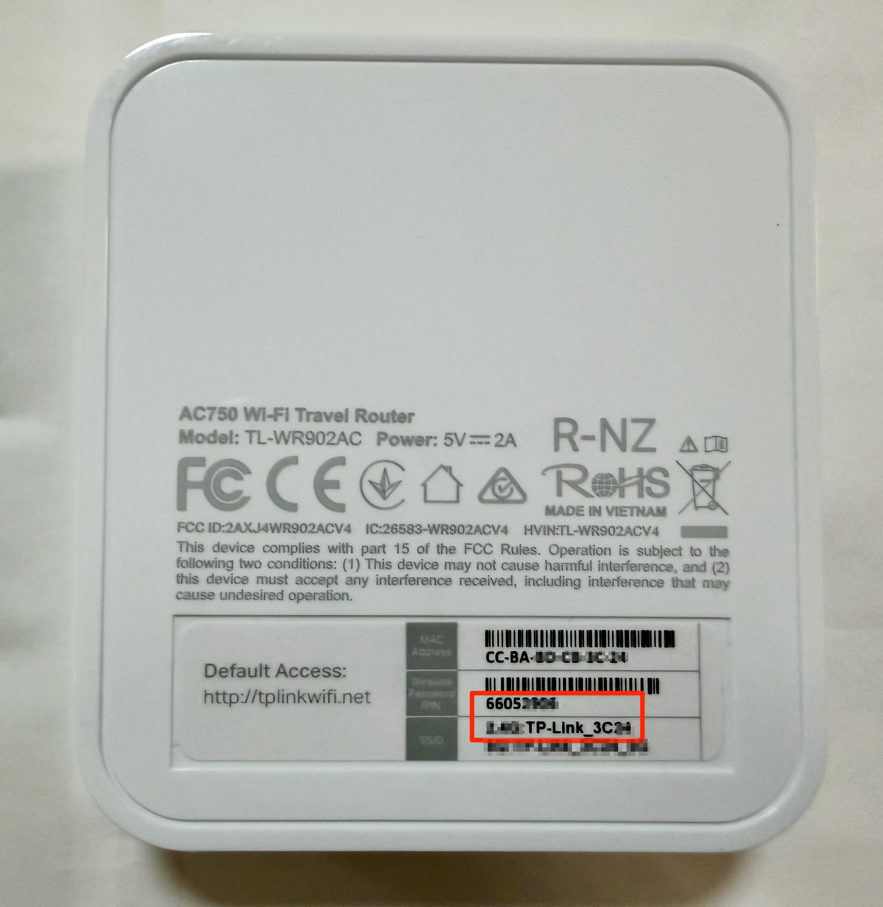 Mini router label showing the network name and password