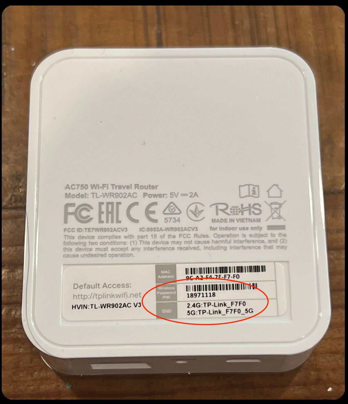 Back of the mini router showing SSID and password label
